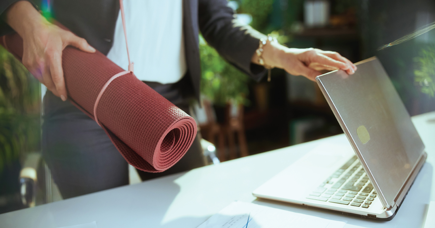 a worker closing their laptop to do yoga