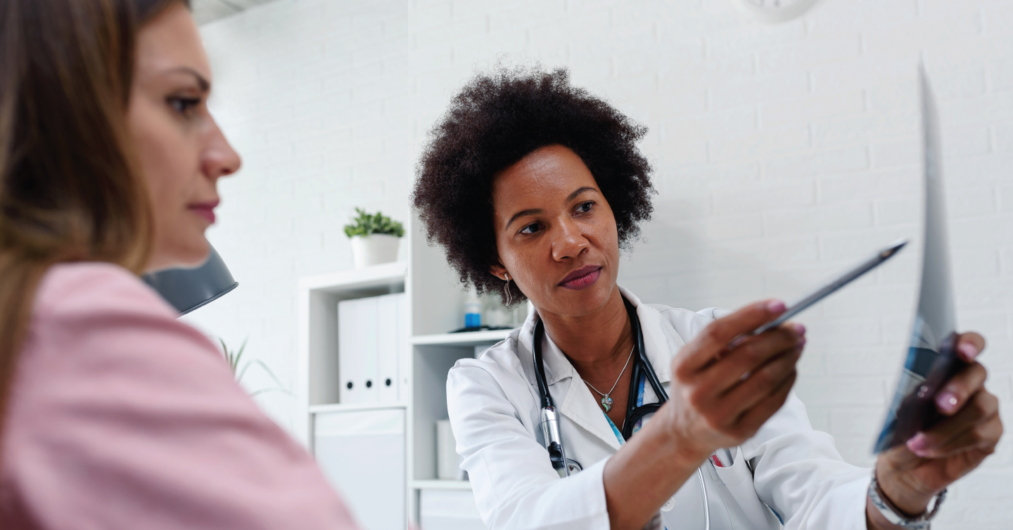 a doctor reviewing a mammogram report with a patient