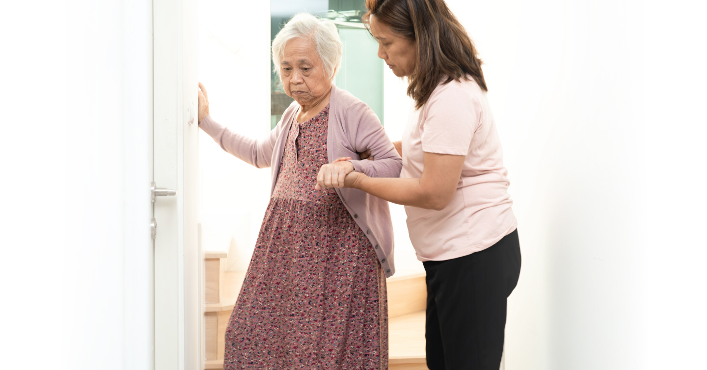 a person helping a senior with walking