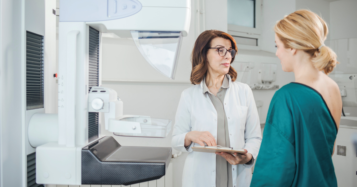 a woman preparing for a mammogram with her doctor