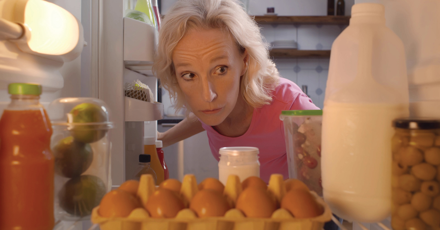 a woman with diabetes looking inside the fridge