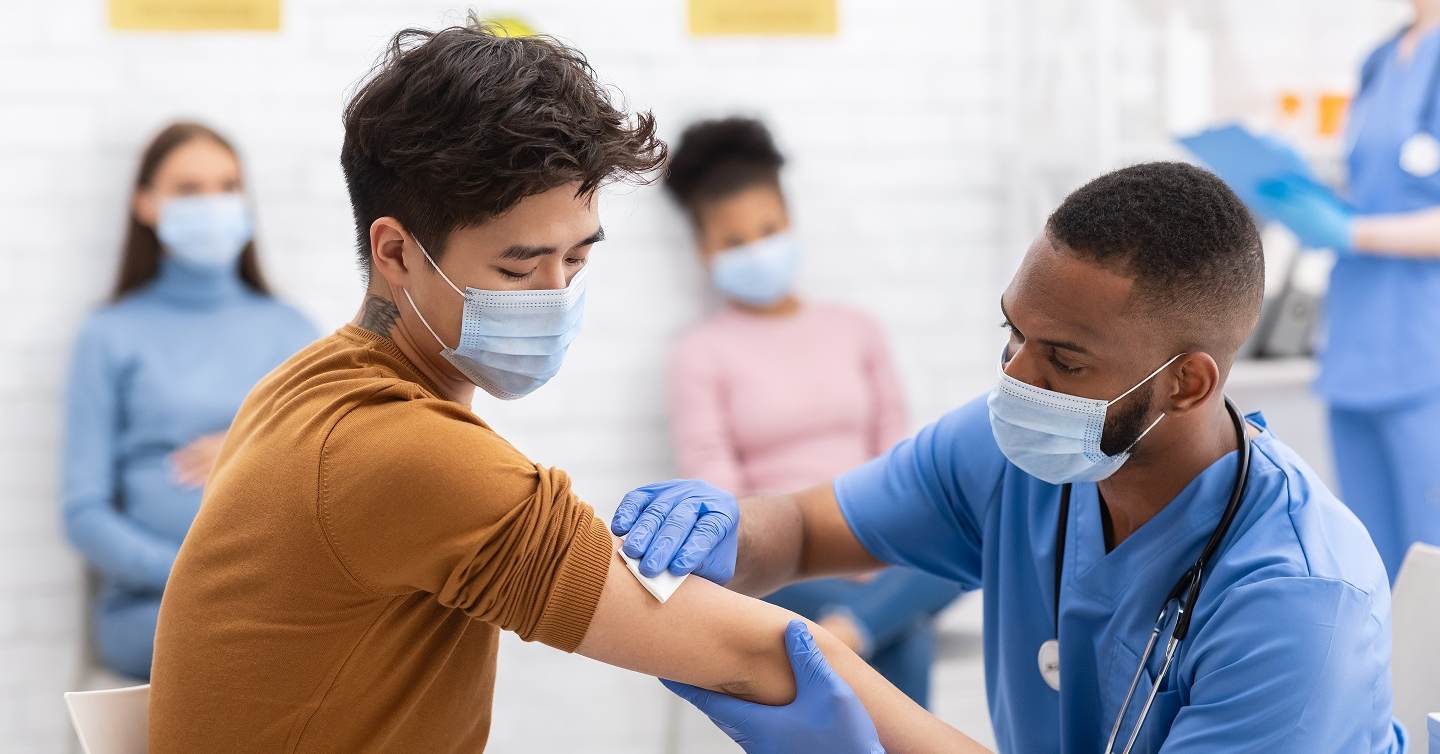 person receiving vaccine from a doctor in a clinic