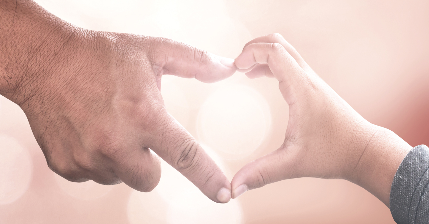 adult and child hands coming together to form a heart