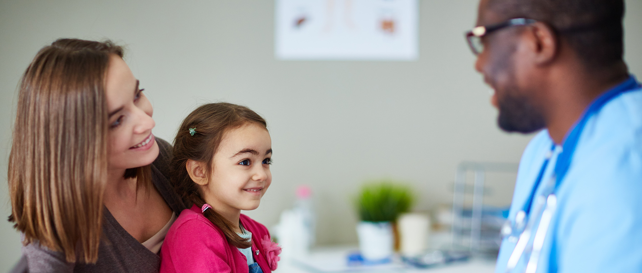child being seen by doctor for back to school checkup