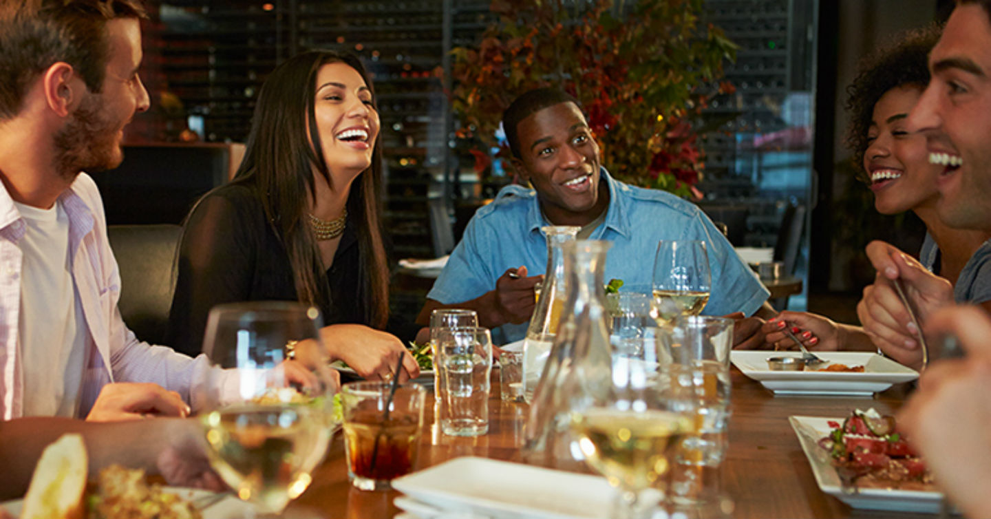 group of jovial acquaintances out to eat