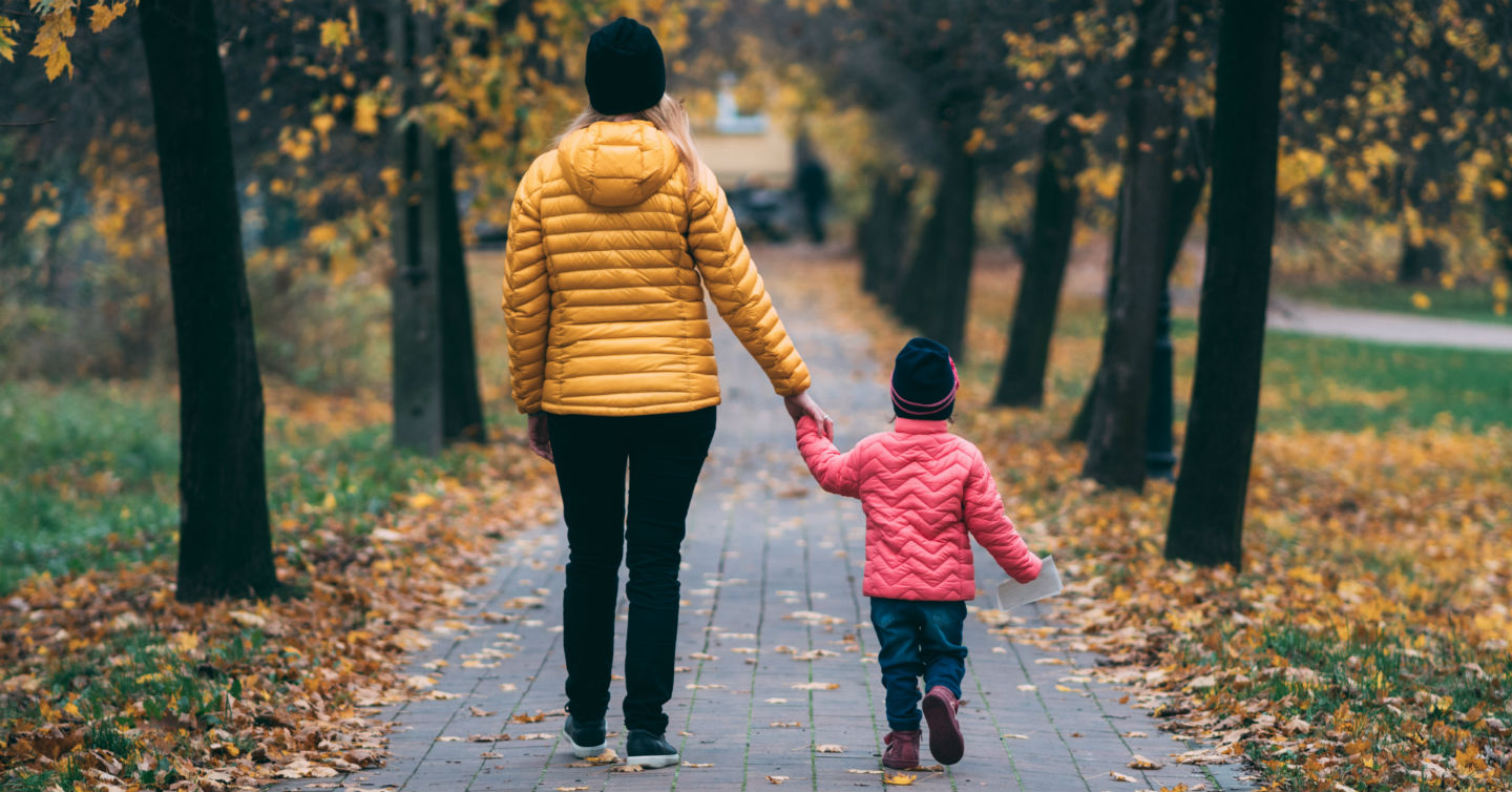 woman walking with child in the woods