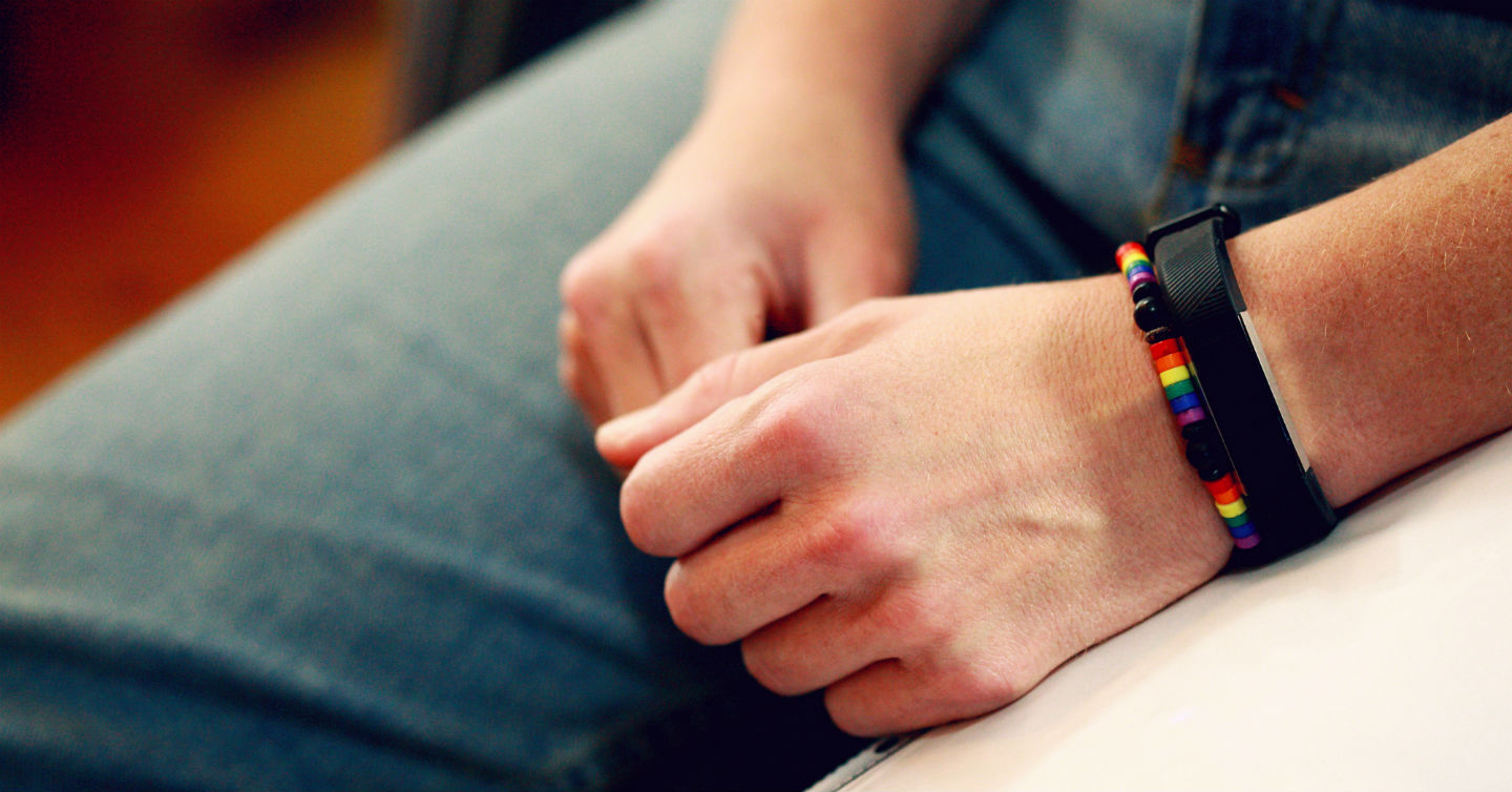 hand with chakra bracelet and fitness tracker on wrist