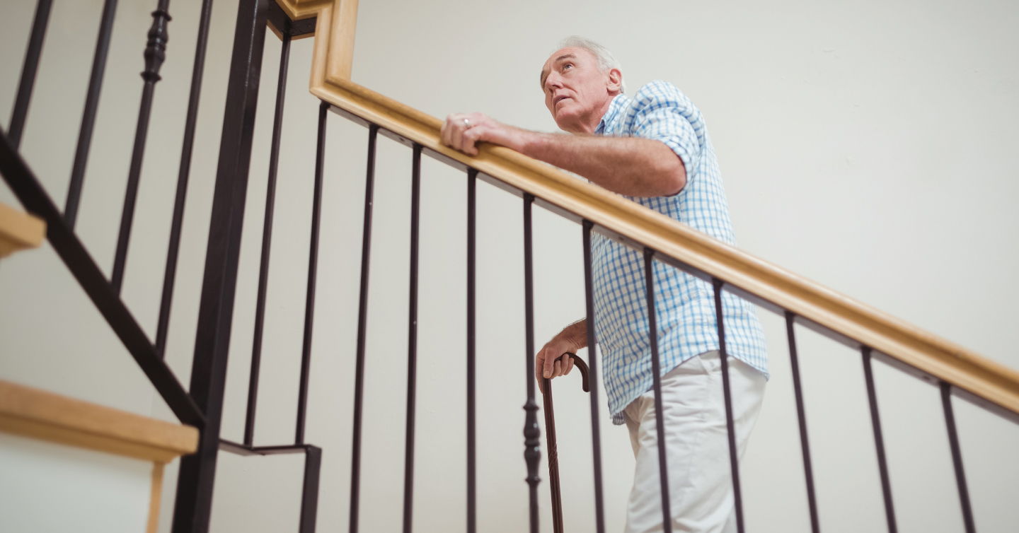 senior man carefully walking up the stairs