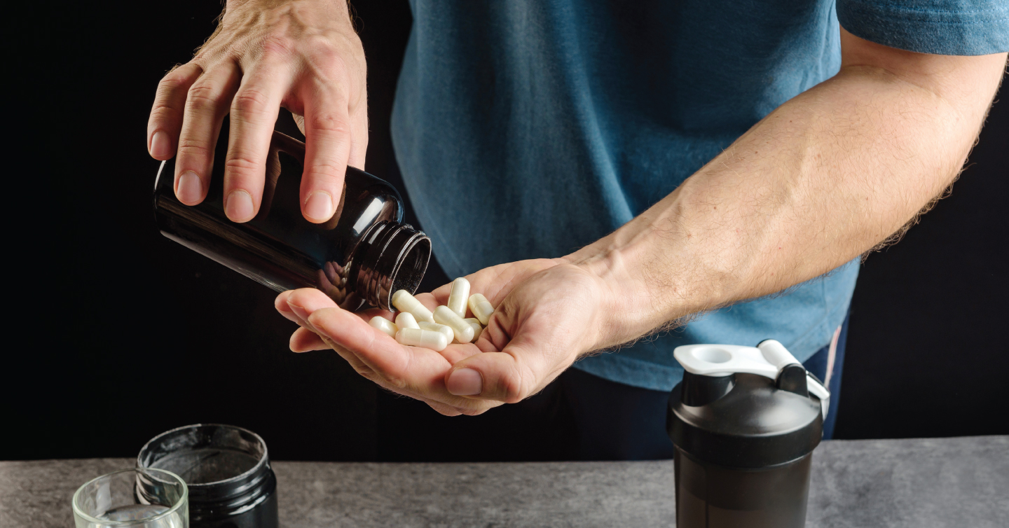 a man emptying a bottle of pills into his hand