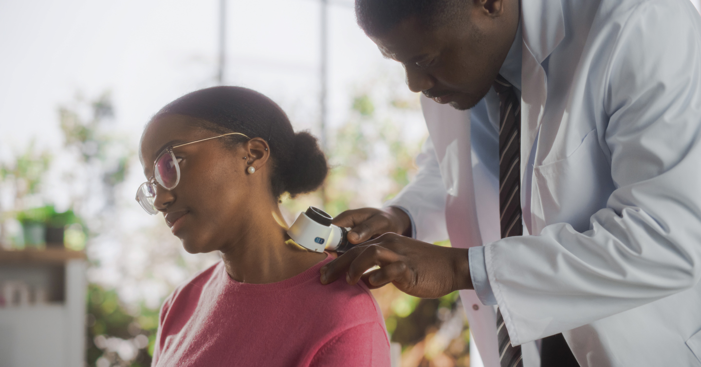 a woman getting he skin looked at by a dermatologist