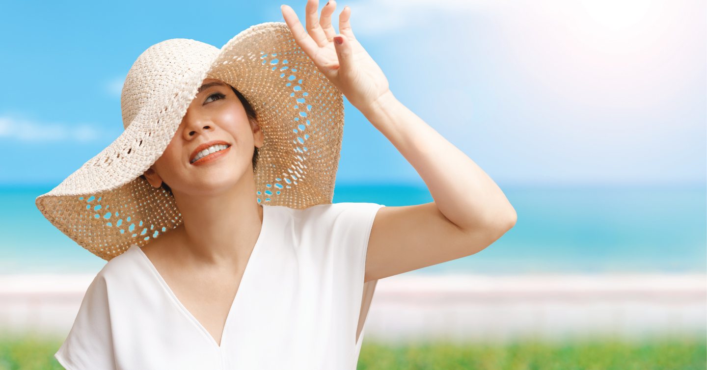 person adorned in large floppy sun hat to protect their skin