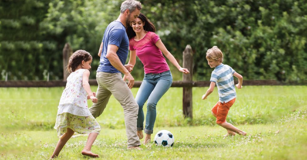 image of a family exercising outside