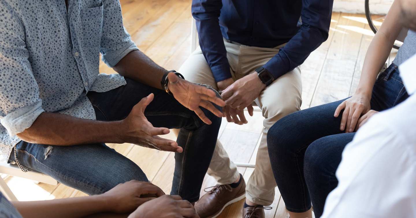 group of people in a committee discussing mental health