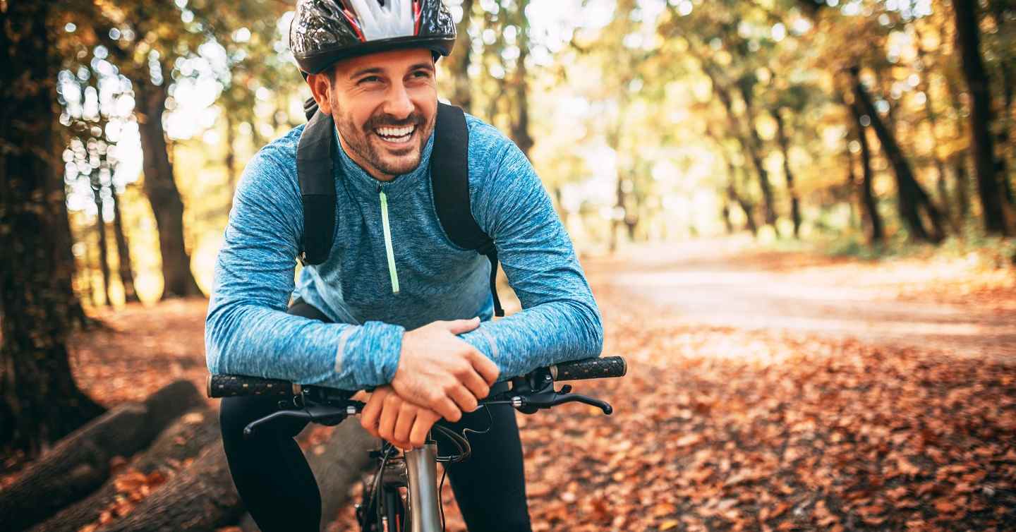 person on bicycle in park looking off camera