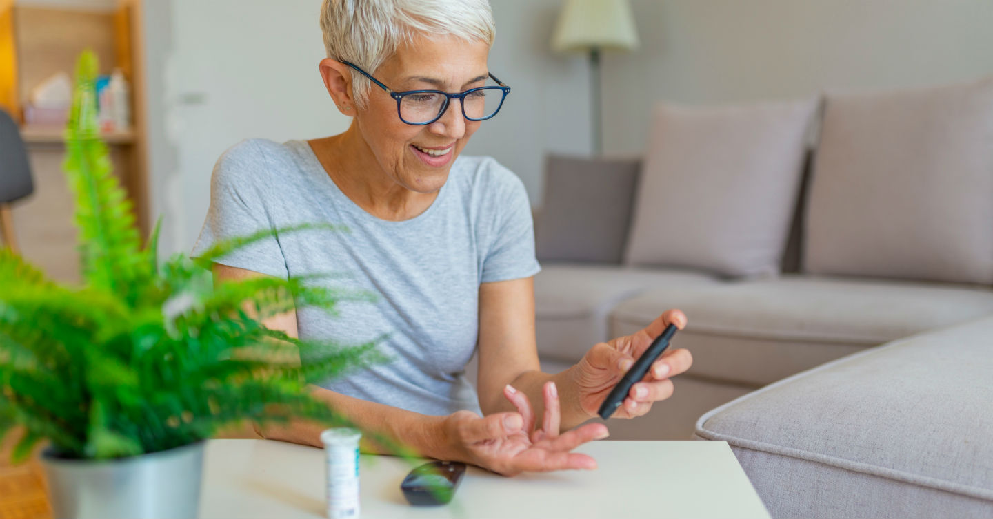 a senior woman testing her blood sugar