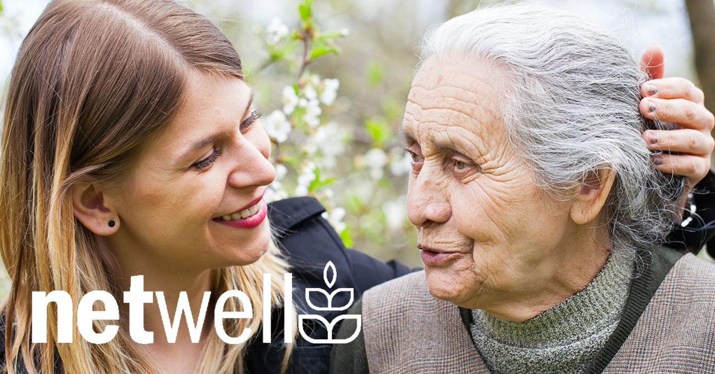 A Woman smiling with another elderly woman