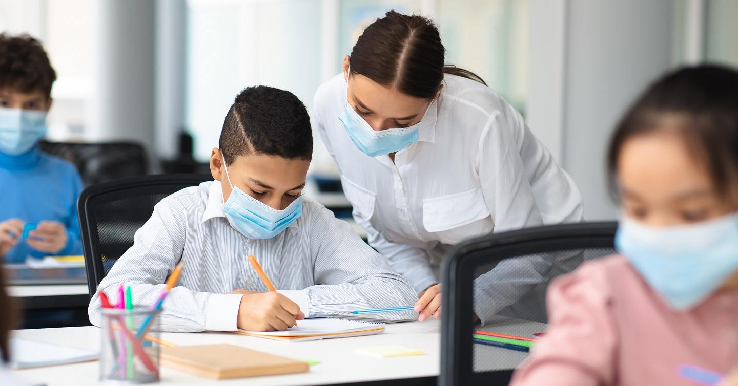 children in a classroom with masks on