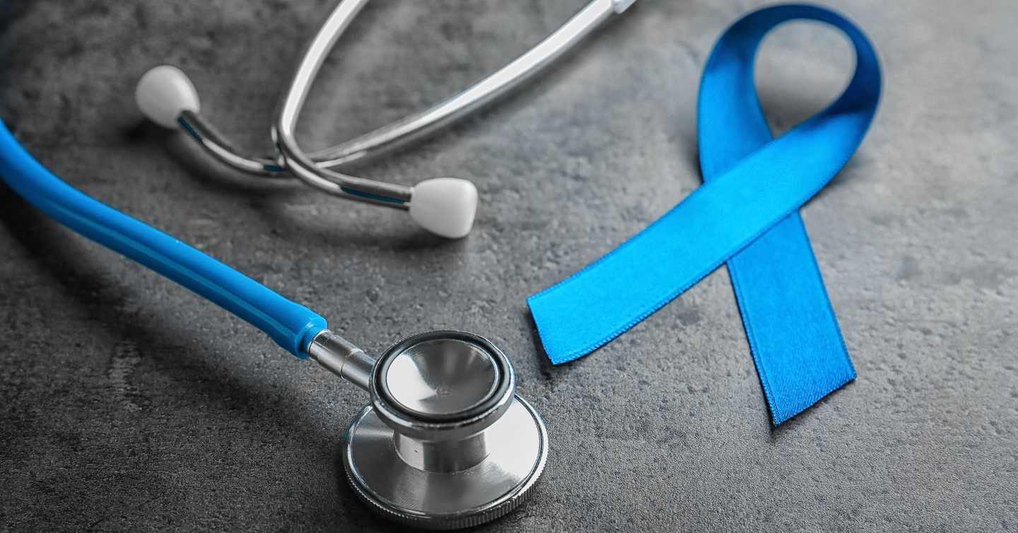 closeup of stethoscope and navy blue ribbon for colorectal cancer