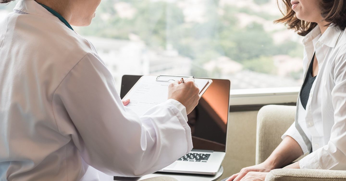 person consulting with their personal doctor about health screenings