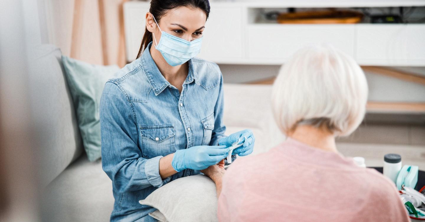 woman receiving checkup at doctor with mask